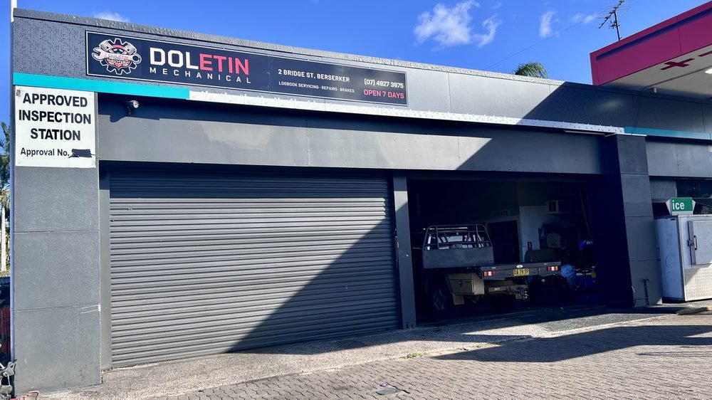 The Doletin Mechanical workshop front at 2 Bridge St, Berserker, with the signed roller door and Approved Inspection Station sign